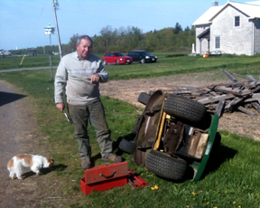 Our neighbor Charlie Foreman gives us the bad news on the lawn tractor. 