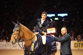 Kalle Sternberg, Brand Manager for Longines, Sweden, presents a Longines watch to Nicola Philippaerts after the young Belgian rider won the last qualifying round of the Longines FEI World Cup™ Jumping 2013/2014 Western European League at Gothenburg, Sweden today. Photo: FEI/Roland Thunholm.