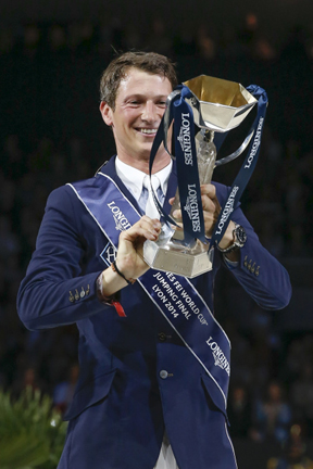 All mine! Germany’s Daniel Deusser looks with delight at the Longines FEI World Cup™ Jumping trophy which he won today following a superb performance with Cornet d’Amour. Photo by FEI/Dirk Caremans