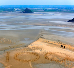 Giant 2.3m by 2.5m horse hoof prints created in the Bay of Mont-Saint-Michel, the famous UNESCO World Heritage Site, by French artist and sand sculptor Christophe Dumont, mark 100 days to the start of the Alltech FEI World Equestrian Games™ 2014 in Normandy, France this summer. (Photo: Dan Towers/FEI).