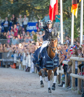 Ingrid Klimke (GER), multiple gold medallist at Olympic, World and European level, with her 10-year-old Horseware Hale Bob (“Bobby”), celebrated in front of excited fans after winning the first leg of FEI Classics™ 2014/15 at Les Etoiles de Pau. Photo by Trevor Holt/FEI