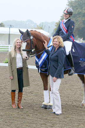 Liz Prest of KBIS Insurance and her daughter, Emma Prest, present Roberta Sheffield and Double Agent with the first place ribbon for winning Grade III test at the KBIS Para Dressage Championship at the Le Mieux National Dressage Championships 2014.