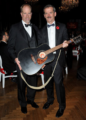 FEI Group IV Chairman Mark Samuel placed the winning bid on the Canadian-made Norman guitar auctioned off by keynote speaker, Canadian astronaut Commander Chris Hadfield, to benefit C-DAAP. Photo by One Shot George