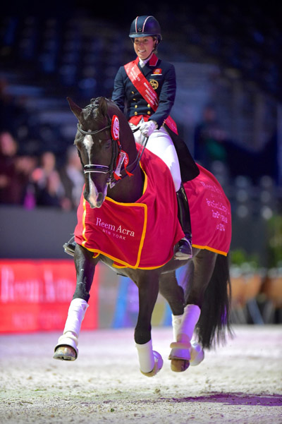 The girl with the floating horse: Charlotte Dujardin (GBR) on a lap of honour with Valegro after their win in the Reem Acra FEI World Cup™ Dressage Final 2014 in Lyon (FRA). Dujardin and Valegro will defend their title in Las Vegas (USA) next month. Photo by FEI/Arnd Bronkhorst