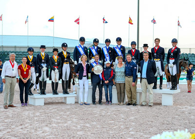 On the podium for the second leg of the FEI Nations Cup™ Dressage 2015 series in Wellington, USA (from left) - third-placed Team Canada 2, Jill Irving, Tina Irwin, Christilot Boylen and Shannon Dueck; the winners, Team USA 1, Kimberly Herslow, Allison Brock, Laura Graves and Olivia LaGoy-Weltz; and second-placed Team Canada 1, Diane Creech, Belinda Trussell, Chris Von Martels and Megan Lane. In the foreground, Arlene Page, Robert Dover, Debbie MacDonald, Diane Sasser, Allyn Mann and Thomas Bauer. Photo by FEI/Susan Stickle