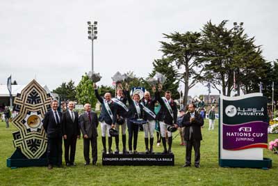 The British team celebrate on the podium after victory at the second leg of the Furusiyya FEI Nations Cup™ Jumping 2015 Europe Division 1 League at La Baule, France today: (L to R) Michael Whitaker, Spencer Roe, Di Lampard (Chef d’Equipe), Joe Clee and Guy Williams. Photo by FEI/Eric Knoll