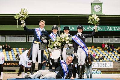 The Swedish team celebrating on the podium after victory in the FEI Nations Cup™ Dressage 2015 pilot series leg at Falsterbo, Sweden today: (L to R, standing) Patrik Kittel, Emilie Nyrerod, Tinne Vilmhelmson-Silfven and Minna Telde, with Chef d'Equipe, Bo Jenå, in front. Photo by FEI/Lotta Gyllensten