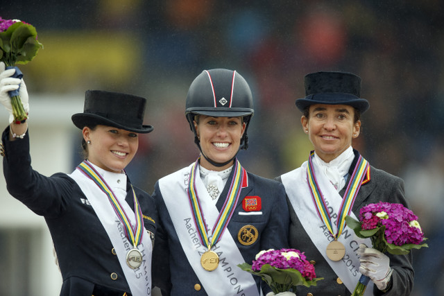 The Grand Prix Freestyle medallists on the podium at the FEI European Dressage Championships 2015 in Aachen, Germany today. (L to R) Kristina Bröring-Sprehe from Germany (silver), Britain’s Charlotte Dujardin (gold) and Spain’s Beatriz Ferrer-Salat (bronze). Photo by FEI/Dirk Caremans