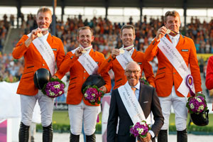 The Netherlands’ (L to R) Jur Vrieling, Gerco Schroder, Maikel van der Vleuten and Jeroen Dubbeldam with Chef d’Equipe Rob Ehrens celebrate team gold at the FEI European Jumping Championships 2015 in Aachen, Germany. Photo by FEI/Dirk Caremans