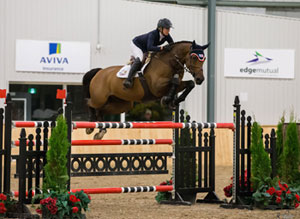 Amy Millar of Perth, ON, guided Heros to victory in the $35,000 CSI2* Caledon Cup – Phase Two in the new indoor arena at the Caledon Pan Am Equestrian Park on Friday night, September 25. Photo by Ben Radvanyi