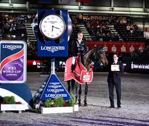 New German sensation, 22-year-old Niklas Krieg, was the surprise winner of today’s ninth leg of the Longines FEI World Cup™ Jumping 2015/2016 Western European League at Leipzig (GER). He is pictured receiving the winner’s Longines watch from Mr Rainer Eckert, Longines Brand Manager for Germany. Photo by FEI/Karl-Heinz Frieler
