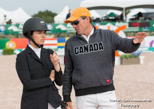 Chris Sorensen goes over the course with student, Quincy Hayes, an up-and-coming jumper rider who recently helped Canada take second place against a total of 17 teams in the Artisan Farms Under 25 Team Event, held Feb. 5, 2016 at the prestigious Winter Equestrian Festival (WEF) in Wellington, FL. Photo by Starting Gate Communications