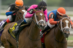 Patrick Husbands guides #6 Lexie Lou (pink silks black cap) to victory in the $200,000 Nassau Stakes at Woodbine. Photo by Michael Burns Photography