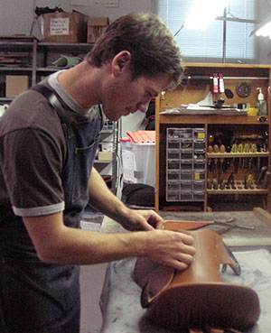 Chris Moloughney shown here setting 'skirts' on a 'blocked' saddle seat during his apprenticeship.