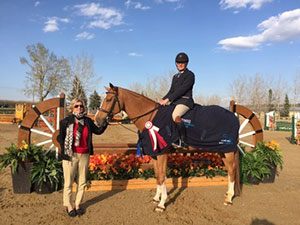 Cornelle and Rodney Tulloch accepting their first red ribbon of the 2016 series at the $4,000 Canadian Hunter Derby at the RMSJ Bow Valley Classic II in May.