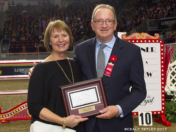 John “JT” Taylor was presented with the 2017 JC Official of the Year Award by Pam Law, Chair of the EC Jumping Committee, at the Royal Horse Show on Nov. 4, 2017 in acknowledgment of his exceptional career as a top FEI Jumping Judge. Photo by Cealy Tetley