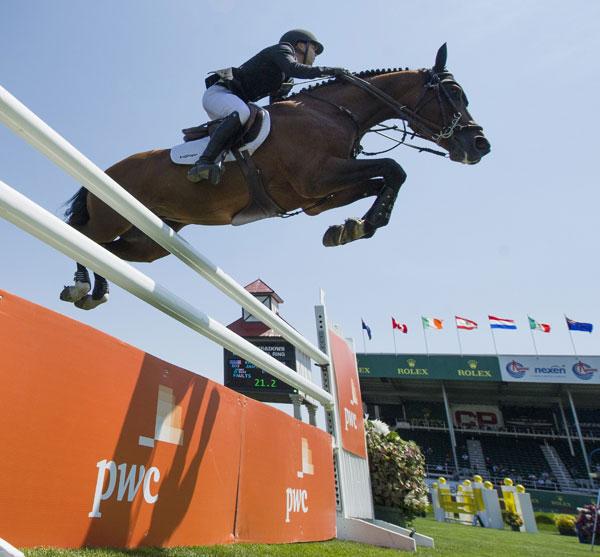 Kent Farrington (BRA) and Jaspar soar over the signature fence in the PwC Cup. Photo by ©Spruce Meadows Media
