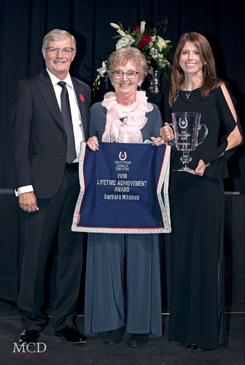 Barbara Mitchell was recognized for her decades of service at the Jump Canada Hall of Fame Induction Ceremony and Gala, presented by BMO Financial Group, on Nov. 4, 2018 at the Liberty Grand in Toronto, ON. She was presented with the 2018 Equestrian Canada (EC) Lifetime Achievement Award by Meg Krueger, EC President, and Craig Collins, EC Director. Photo by Michelle C. Dunn