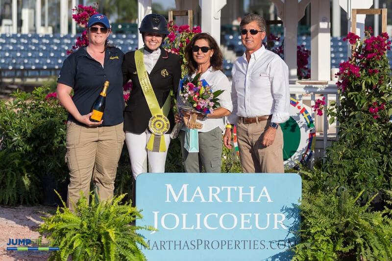 Martha Jolicoeur (right) and Dr. Stephen Norton (far right) present the first Martha Jolicoeur Leading Lady Rider Award of the 2019 Winter Equestrian Festival season to Tiffany Foster (left) and owner Ariel Grange (far left) in Wellington, FL. Photo by Jump Media