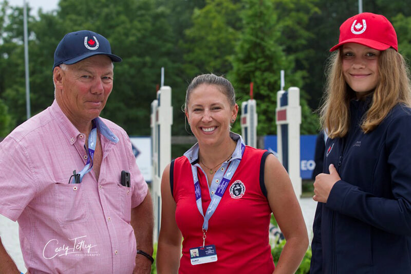 Dayton Gorsline (left) of Okotoks, AB, has been appointed to the position of Equestrian Canada Jumping Youth Development Program Advisor. He is pictured with grand prix rider, Ashleigh Charity (middle), and his student, Olivia Stephenson (right), at the 2018 FEI North American Youth Championships. Photo by Cealy Tetley