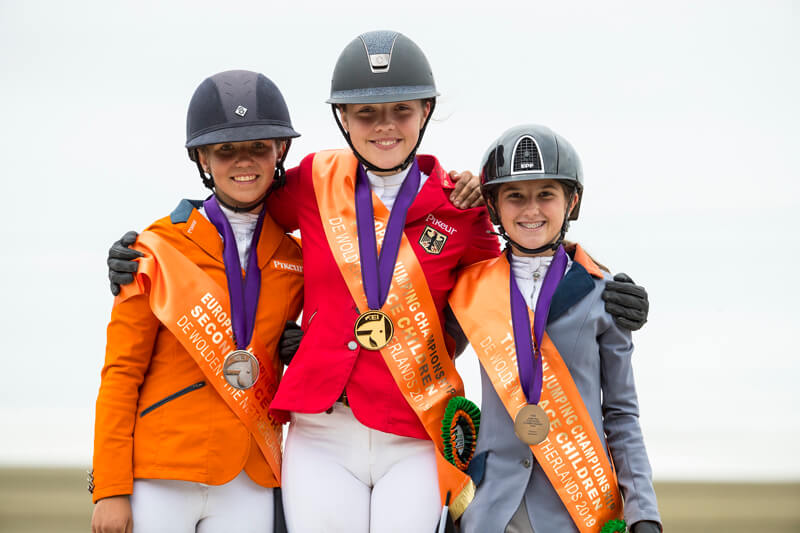 On the podium for the Children's Championship at the FEI Jumping European Championships for Children, Juniors and Young Riders 2019 at Zuidwolde (NED) - (L to R) The Netherlands' Emma Bocken (silver) , Germany's Tiara Bleicher (gold) and Bulgaria's Aya Miteva (bronze). Photo by FEI/Leonjo de Koster