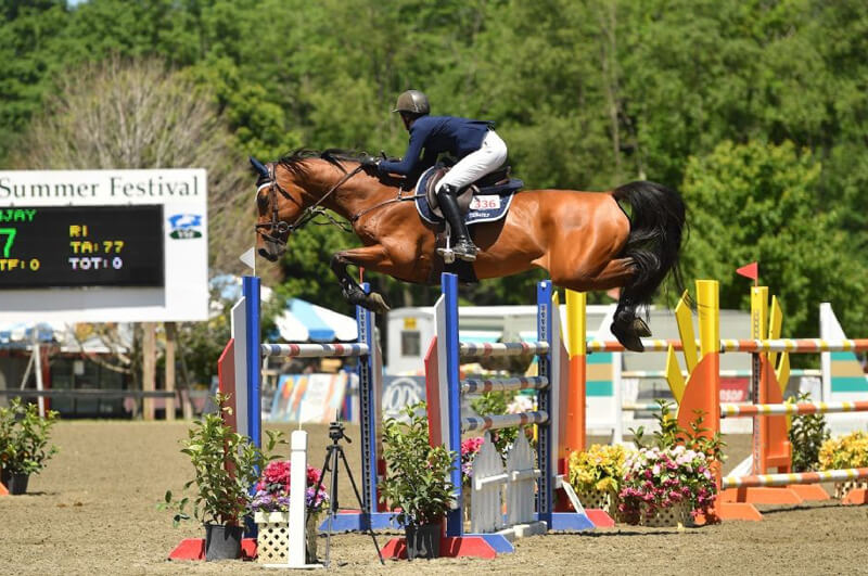 Alexanne Thibault won the $10,000 Show Jumping Hall of Fame High Junior/Amateur-Owner Jumper Classic riding Sanjay at the Vermont Summer Festival. Photo by Andrew Ryback Photography