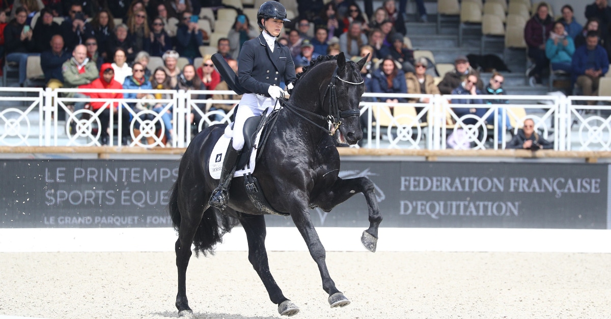 Charlotte Fry and Glamourdale cantering in the ring at Fontainebleau.