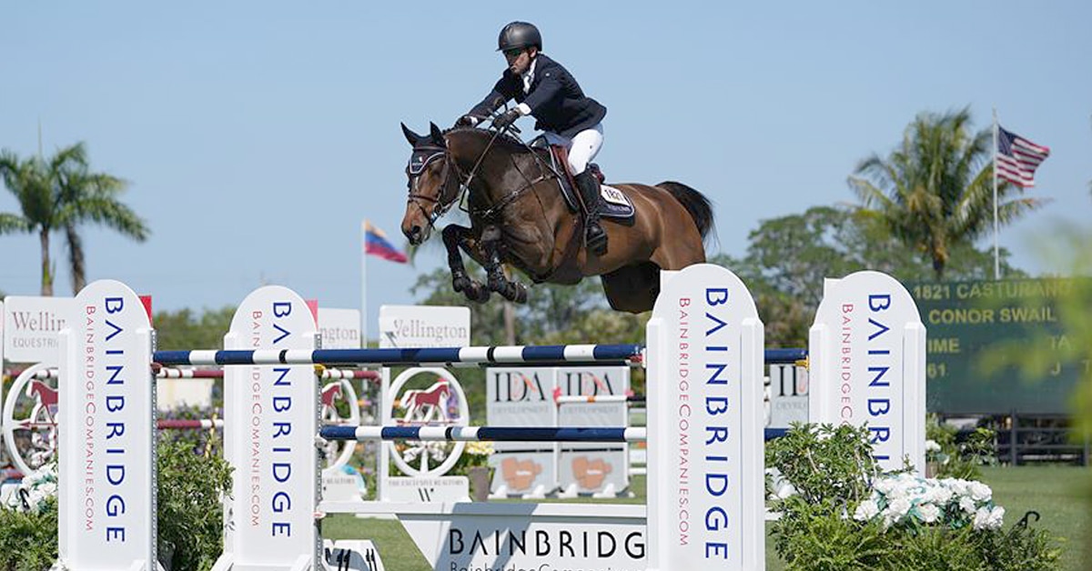 Conor Swail and Casturano jumping over a fence.