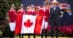 The Canadian jumping Team standing holding a Canadian flag.