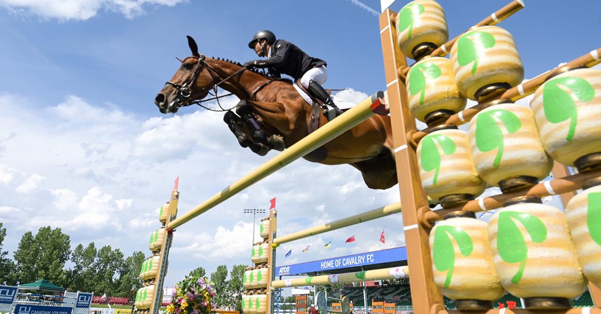 Kent Farrington and Toulayna jumping a fence at Spruce Meadows.
