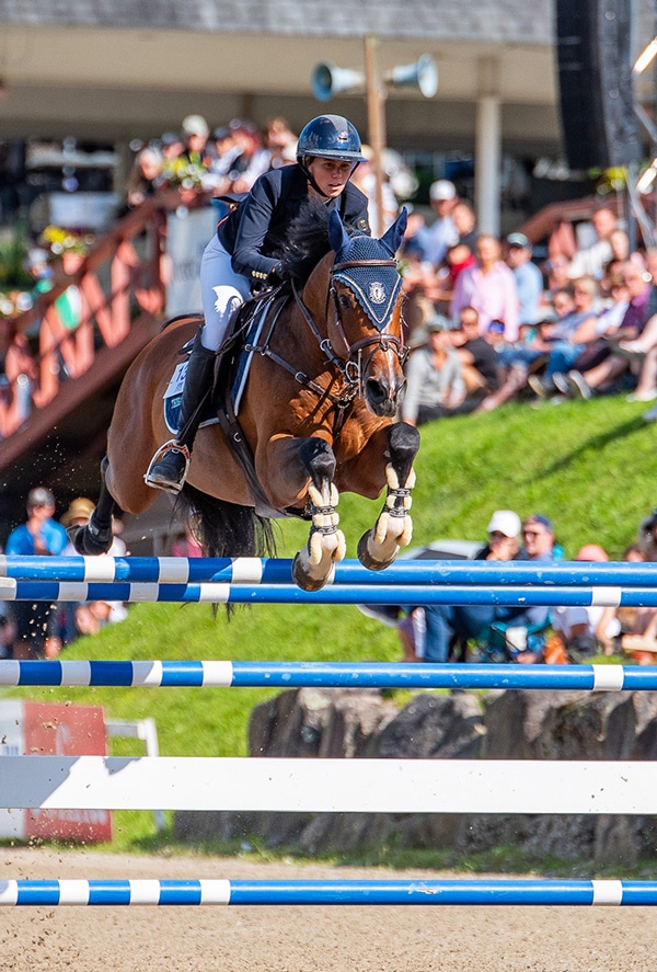 A woman and horse jumping a fence at Bromont.