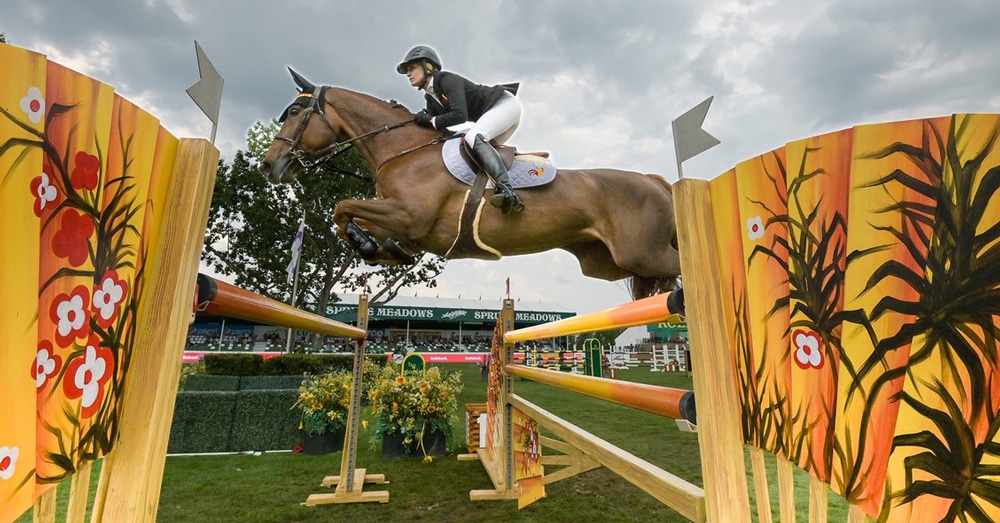 Tiffany Foster and Electrique jump a fence at Spruce Meadows.