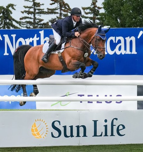Jim Ifko and Un Diamant des Forets jumping a fence at Spruce Meadows.