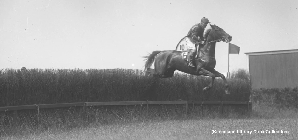 A black-and white photo of a steeplechase race.