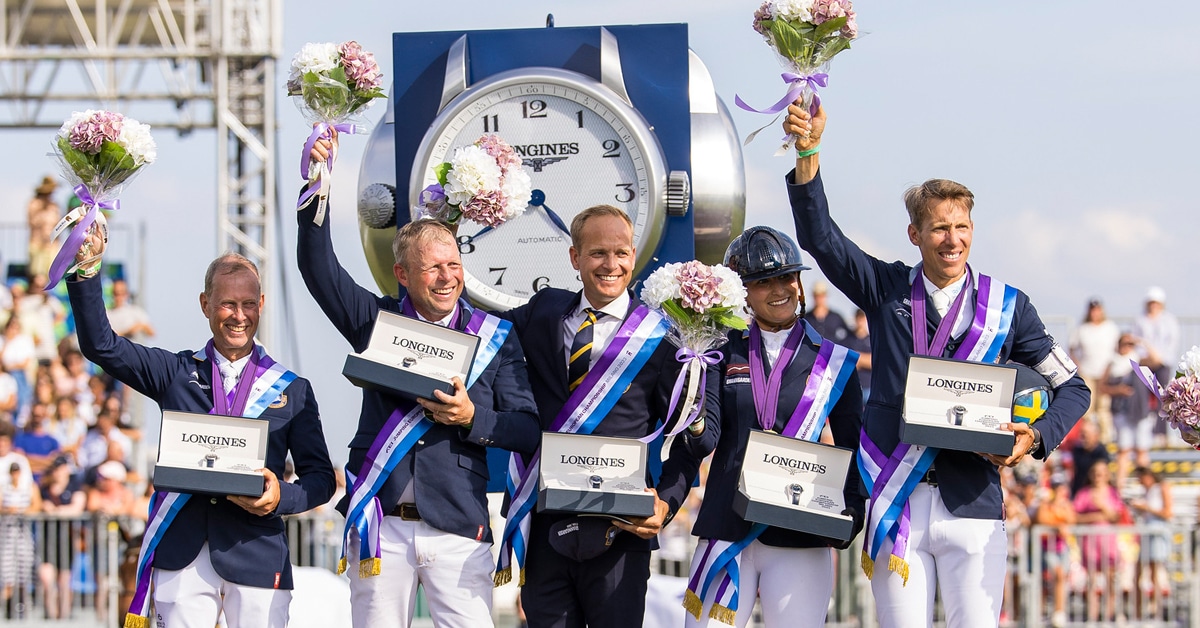 Team Sweden on the podium holding watches and flowers.
