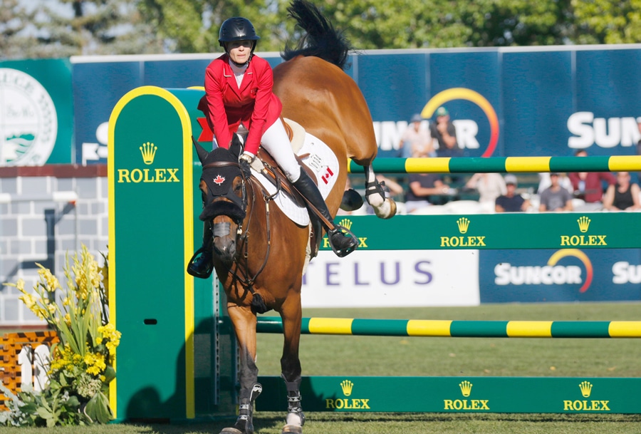 Tiffany Foster and Figor jumping a fence at Spruce Meadows.