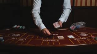 A casino dealer with cards.
