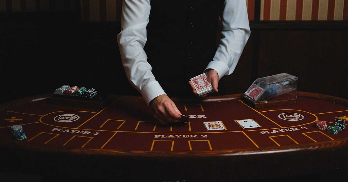 A casino dealer with cards.