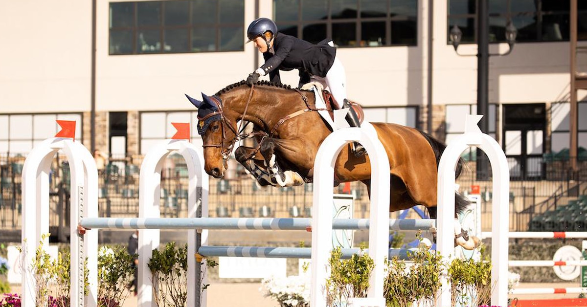 A horse and rider jumping a fence in Tryon.