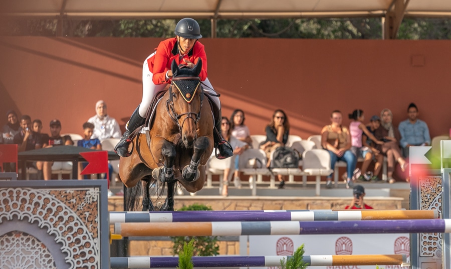 Virginie Thonon jumping a fence in Rabat.