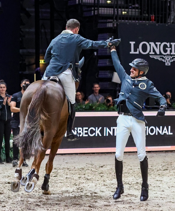 A rider giving his team member a high-five.