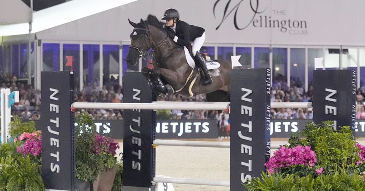 Tiffany Foster and Battlecry jumping a fence at WEF.