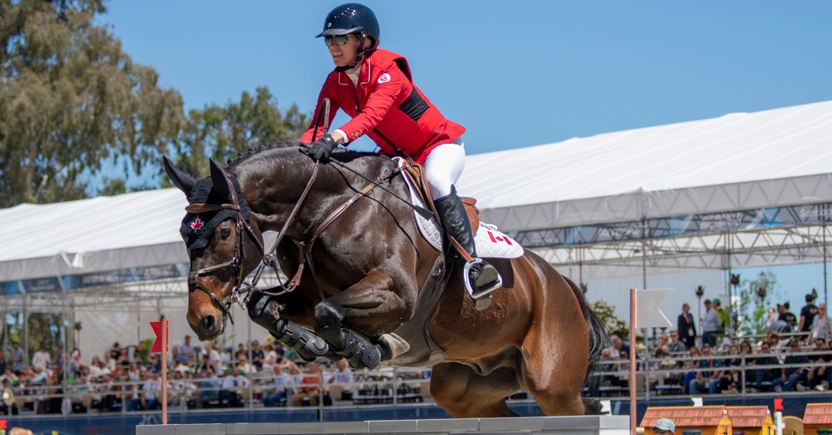 Amy Millar and Truman jumping a fence at the Pan Am Games.
