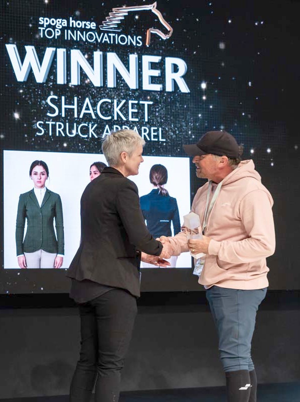 A man receiving an award on stage.