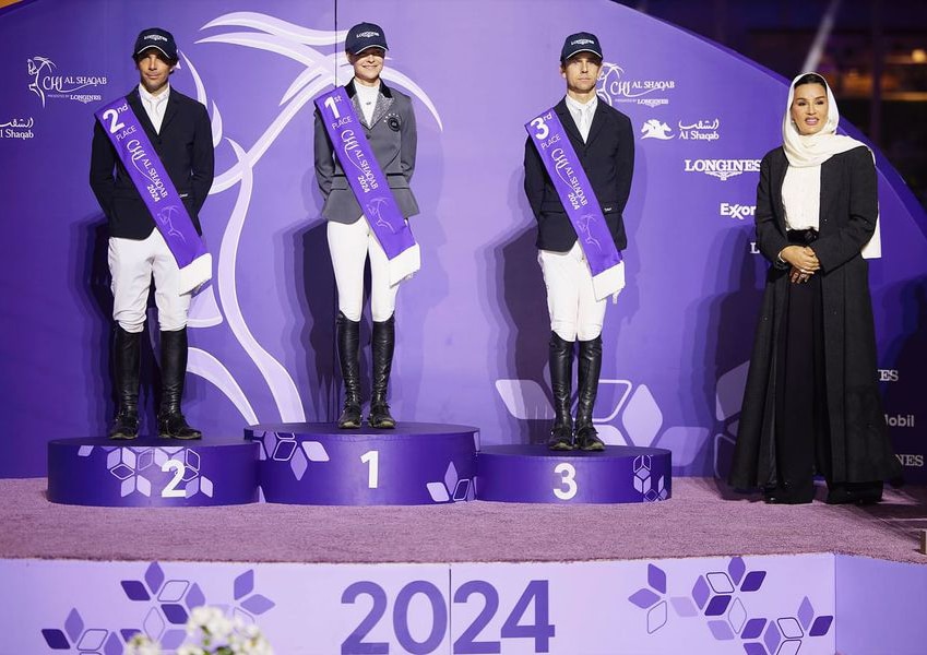 Three riders standing on a podium.
