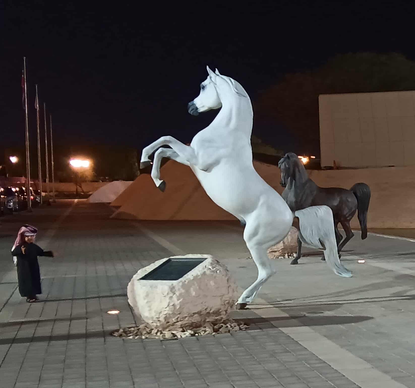 A white rearing horse statue.