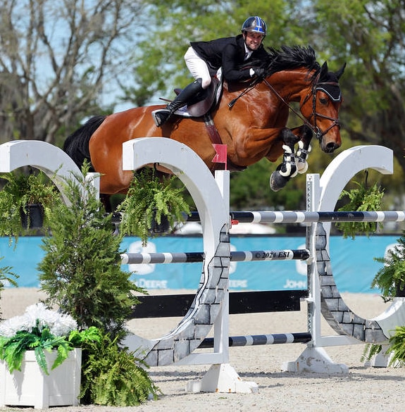A horse and rider jumping a fence in Ocala.