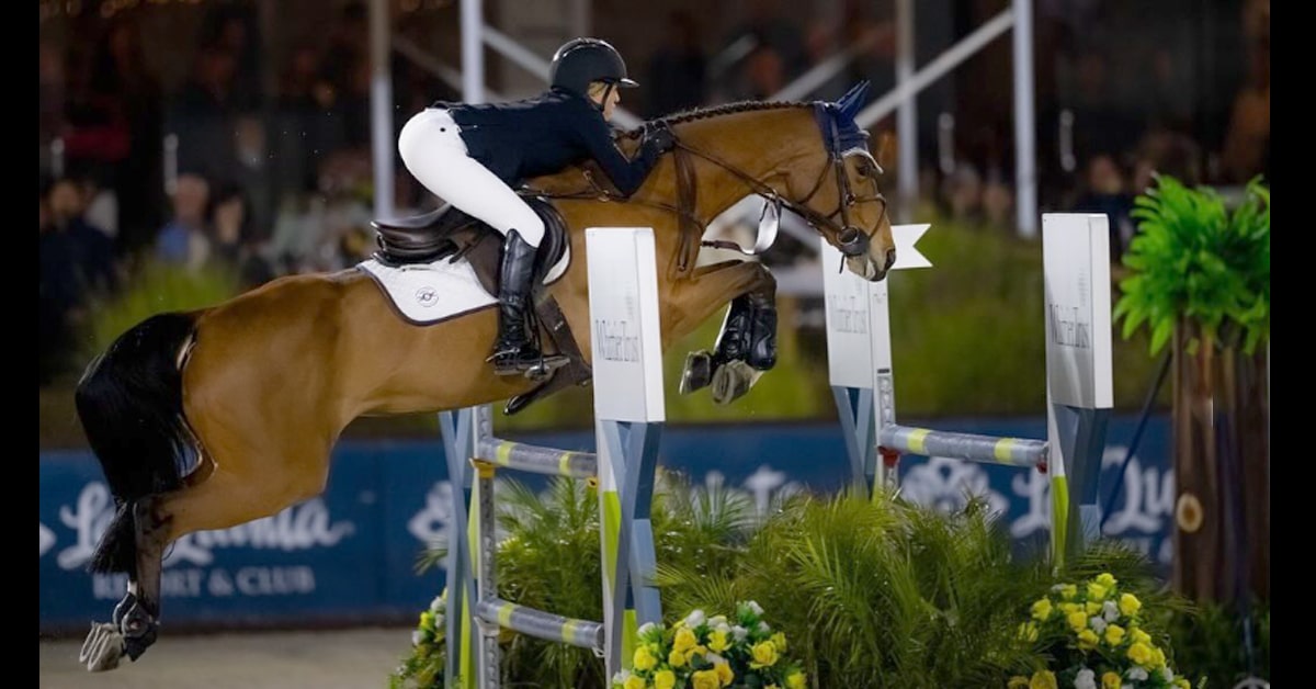 A horse and rider jumping a fence in Thermal.