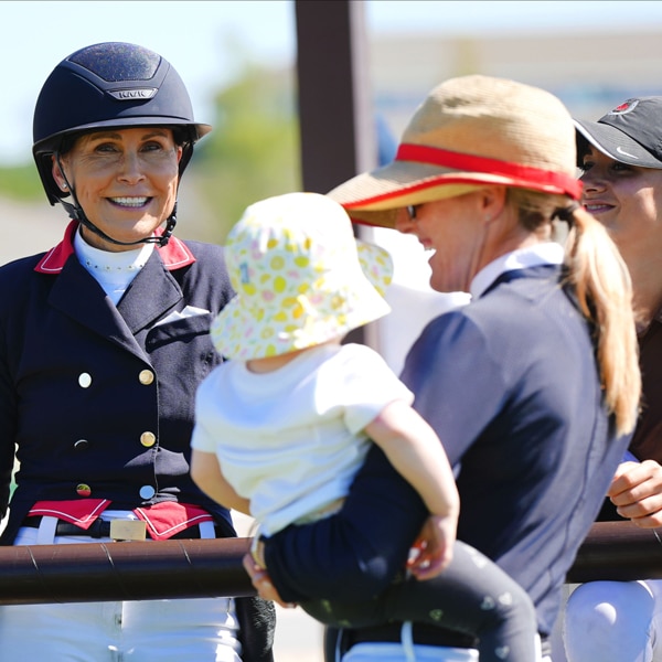 A dressage rider with a woman and a baby.