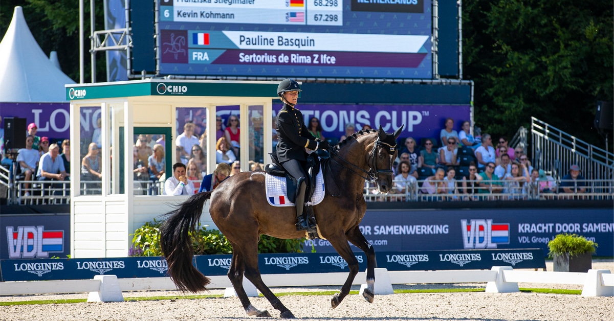 A woman riding a dressage horse in a Nations Cup in Rotterdam.